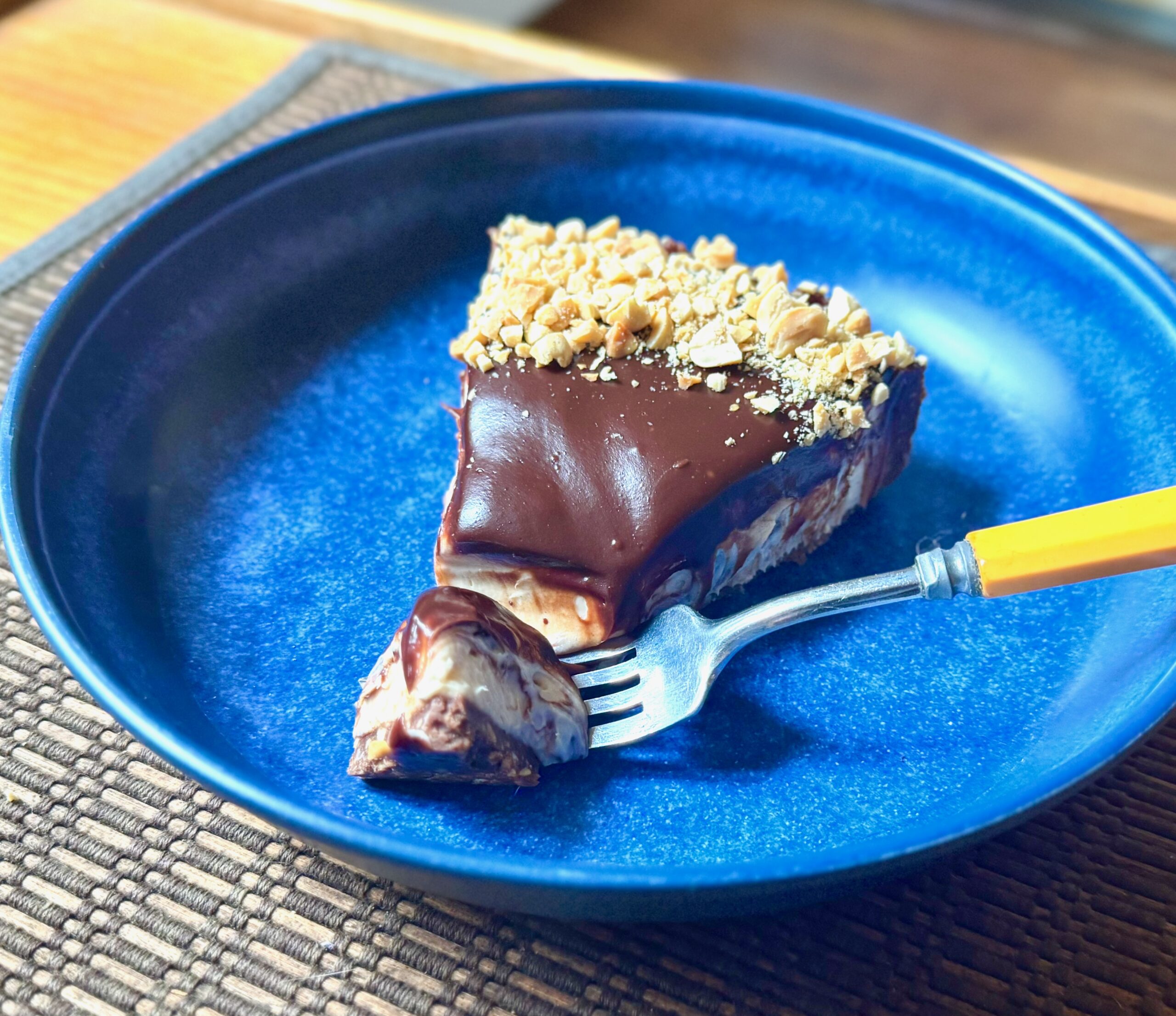 slice of chocolate peanut cheesecake tart
