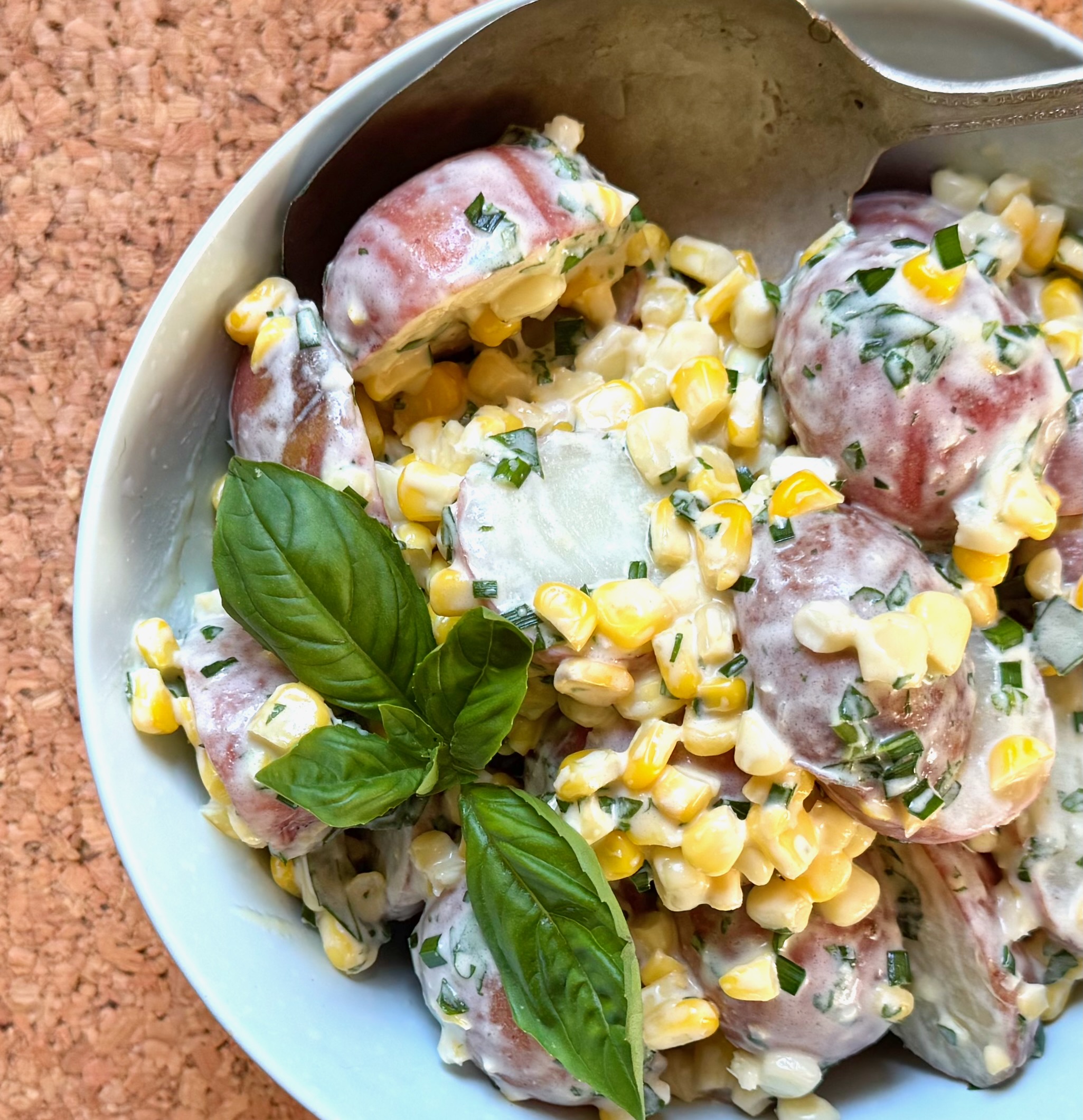 closeup of herbed corn potato salad 